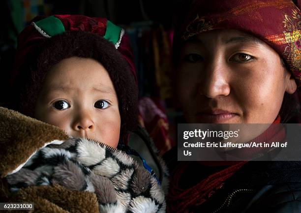 Kyrgyz mother and her child near Karakul lake, Xinjiang Uyghur Autonomous Region, China on September 21, 2012 in Karakul Lake, China.