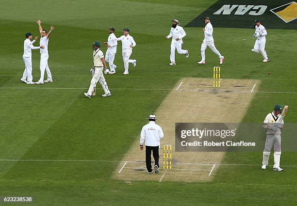 Kyle Abbott of South Africa celebrates after taking the wicket of Mitchell Starc of Australia during day four of the Second Test match between...