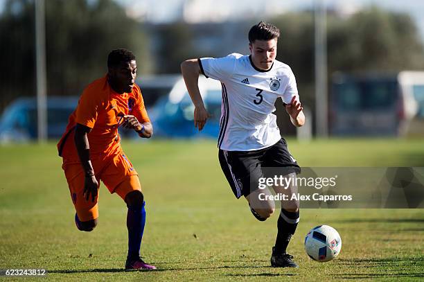 Niklas Kolle of Germany competes for the ball with Che Nunnely of Netherlands during the U18 international friendly match between Netherlands and...