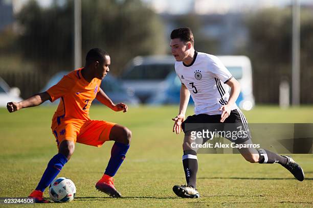 Niklas Kolle of Germany and Navajo Bakboord of Netherlands compete for the ball during the U18 international friendly match between Netherlands and...