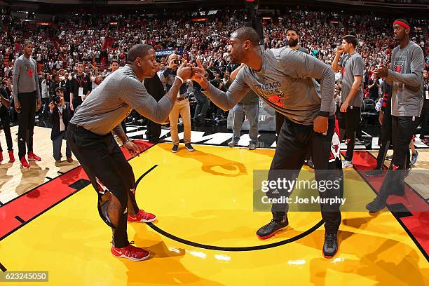 Dwyane Wade of the Chicago Bulls does a hand shake with his teammate Isaiah Canaan of the Chicago Bulls before the game against the Miami Heat on...