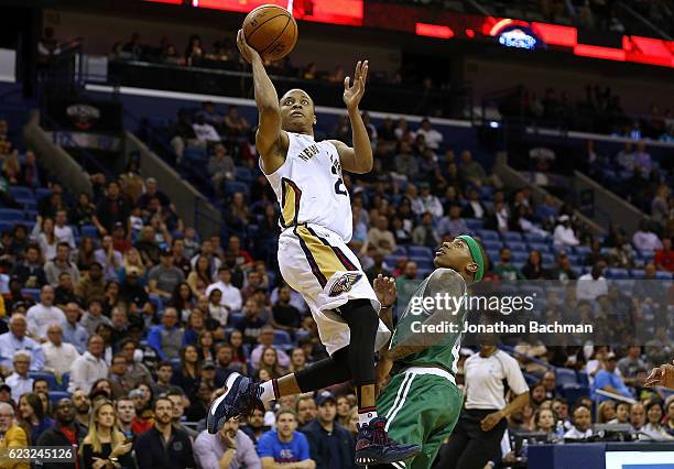 Tim Frazier of the New Orleans Pelicans shoots over Isaiah Thomas of the Boston Celtics during the second half of a game at the Smoothie King Center...