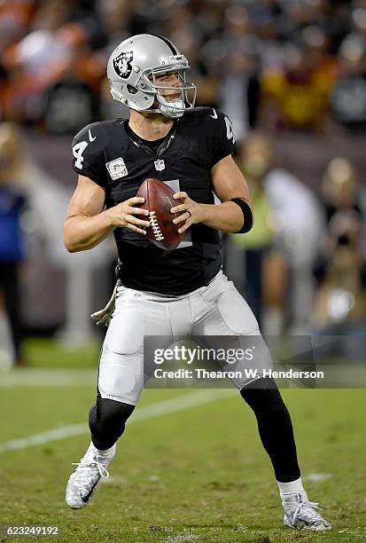 Derek Carr of the Oakland Raiders drops back to pass against the Denver Broncos in the second quarter of an NFL football game at the Oakland-Alameda...