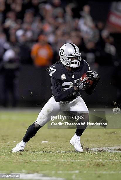 Reggie Nelson of the Oakland Raiders intercepts a pass against the Denver Broncos in the fourth quarter of an NFL football game at the...