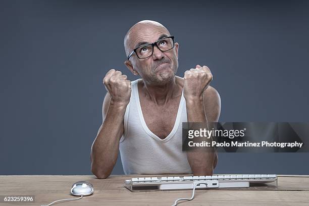 angry man using computer - computer mouse table stock pictures, royalty-free photos & images