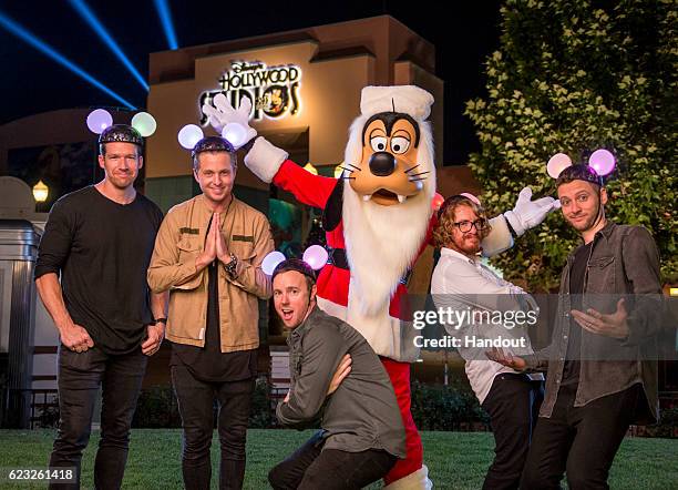 Members of OneRepublic pose with Goofy Nov. 13, 2016 after taping for the ABC holiday TV specials, "The Wonderful World of Disney: Magical Holiday...