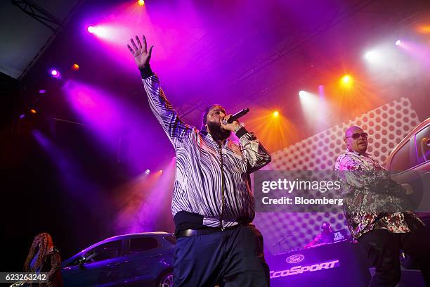 Musicians DJ Khaled, center, and Fat Joe perform as Ford Motor Co. EcoSport crossover sport utility vehicles sit on display after being revealed on...