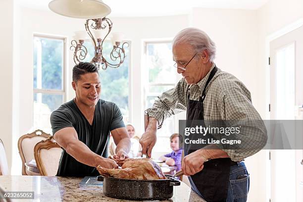 grandfather preparing thanx giving dinner - lise gagne stock pictures, royalty-free photos & images