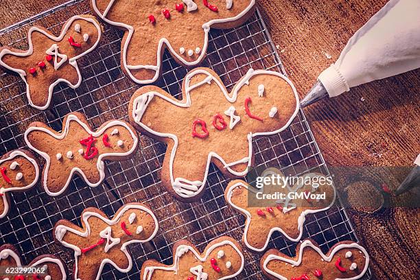 decorating christmas cookies with icing - baking-photos stock pictures, royalty-free photos & images