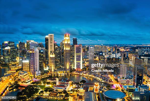 central business district in singapore at dusk - merlion park singapore stock pictures, royalty-free photos & images