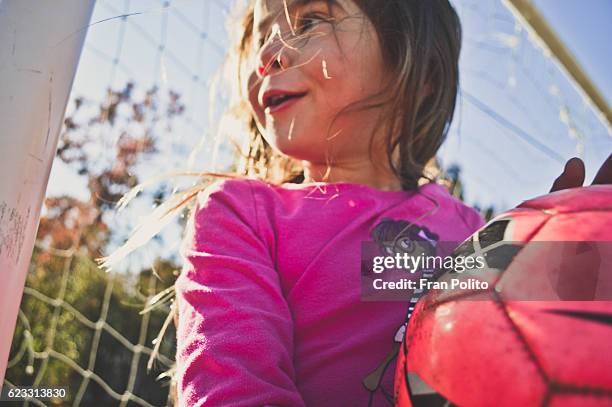 young girl playing soccer. - girl goalkeeper stock pictures, royalty-free photos & images