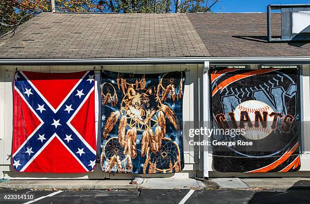 The Confederate flag and a San Francisco Giants banner is displayed outside a Maggie Valley gift shop on October 22, 2016 in Cherokee, North...