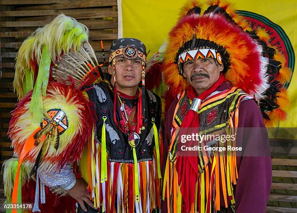 Two Cherokee Native American dancers pose for pictures along the highway on October 22, 2016 in Cherokee, North Carolina. Located near the entrance...