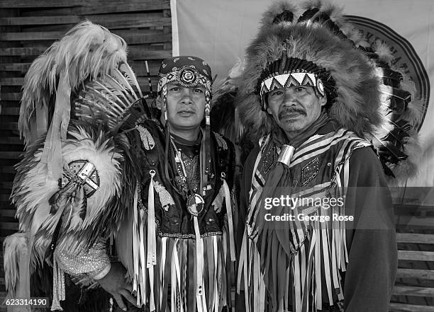 Two Cherokee Native American dancers pose for pictures along the highway on October 22, 2016 in Cherokee, North Carolina. Located near the entrance...