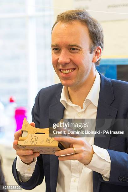 Minister for Digital Policy Matt Hancock uses a Google Cardboard VR headset during a visit to Argyle Primary School, in London, alongside Google CEO...