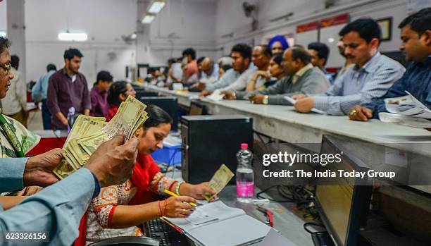 People queue up inside a post office to exchange their old Rs 500 and 1000 notes in New Delhi.