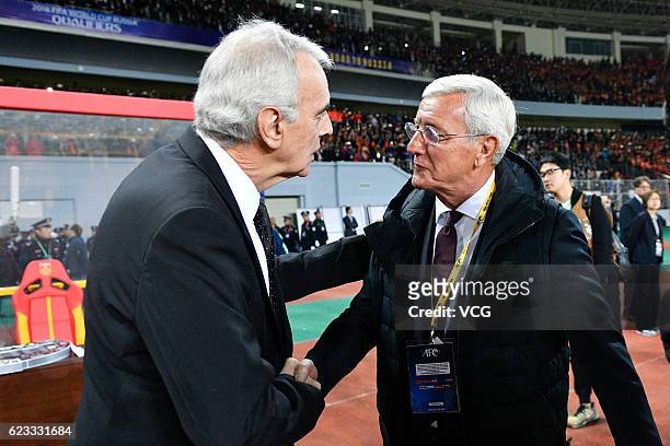 Head coach Jorge Fossati of Qatar and head coach Marcello Lippi of China shake hands during the 2018 FIFA World Cup Qualifier match between China and...