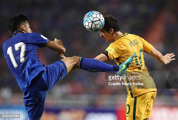 Tanaboon Kesarat of Thailand jumps to clear the ball as Robbie Kruse of the Socceroos heads the ball during the 2018 FIFA World Cup Qualifier match...