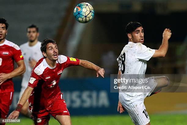 Alireza Jahan of Iran battles with Mouaiad Al Ajjan of Syria during the 2018 FIFA World Cup Qualifier match between Iran and Syria at Tuanku Abdul...