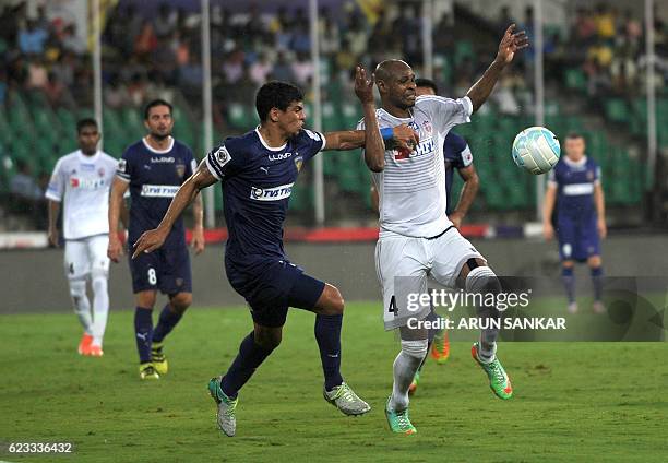 Chennaiyin FC defender Eder Monteiro vies for the ball with FC Pune City's forward Dramane Traore during the Indian Super League football match...