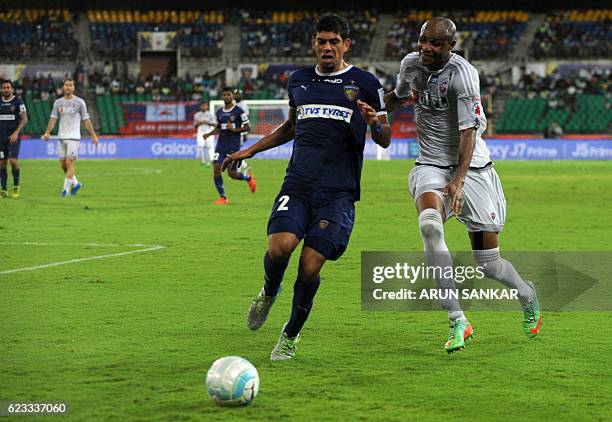 Chennaiyin FC defender Eder Monteiro vies for the ball with FC Pune City's forward Dramane Traore during the Indian Super League football match...