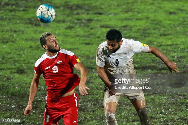 Omid Ebrahim of Iran in an aerial duo with Ahmad Aldouno of Syria during the 2018 FIFA World Cup Qualifier match between Iran and Syria at Tuanku...