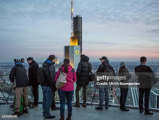 The Frankfurt banking district in the Blue Hour. The photo shows the head office of Commerzbank AG and tourists on a viewing platform.