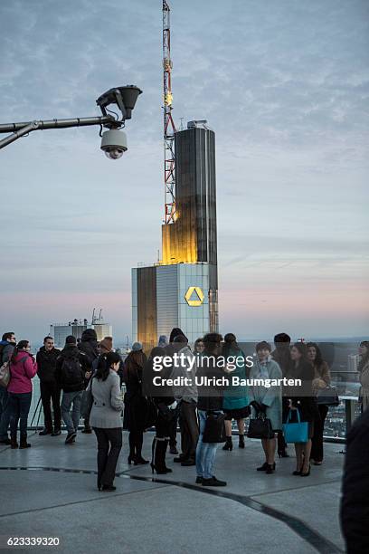 The Frankfurt banking district in the Blue Hour. The photo shows the head office of Commerzbank AG and tourists on a viewing platform.