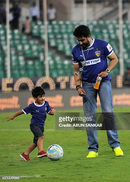 Chennaiyin FC's owner Abishek Bachan plays soccer with kids after the Indian Super League football match between Chennaiyin FC and FC Pune City at...