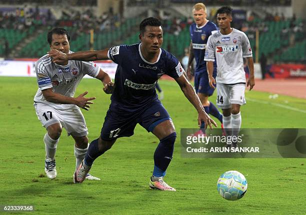 Chennaiyin FC' forward Jeje Lalpekhlua vies for the ball with FC Pune City's defender Yamnam Raju during the Indian Super League football match...