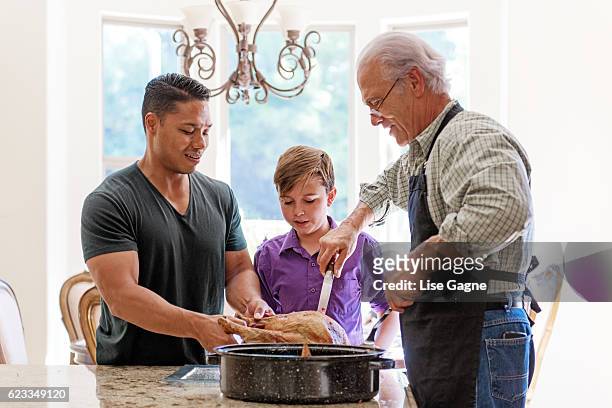 grandfather preparing thanx giving dinner - lise gagne stock pictures, royalty-free photos & images