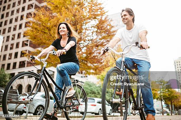 mature couple on bikes in austin texas - austin texas city stock pictures, royalty-free photos & images