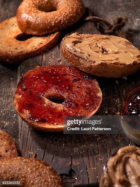 toasted bagels with peanut butter and jam - peanut butter toast stock pictures, royalty-free photos & images