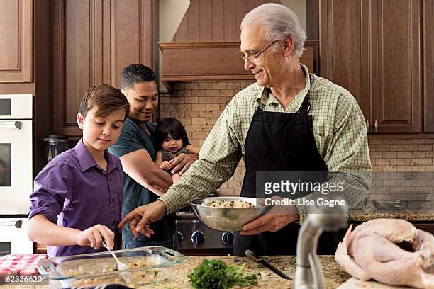 blended family preparing thanksgiving dinner together - lise gagne stock pictures, royalty-free photos & images
