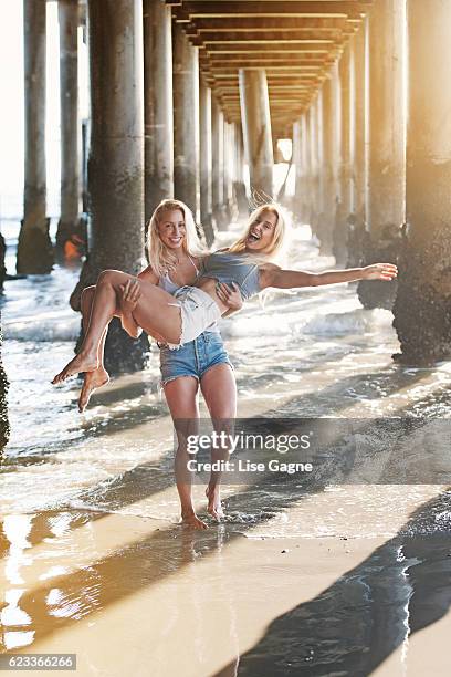 fitness twins under the pier - lise gagne stock pictures, royalty-free photos & images