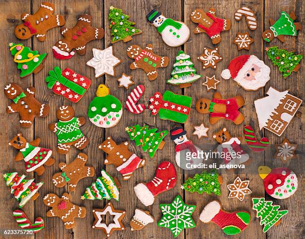 delicious beautiful christmas gingerbread cookies on wooden table. - christmas treat stock pictures, royalty-free photos & images