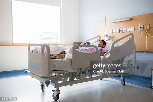 old woman on hospital bed, oxygen tubes in her nose - oxygen tube stock pictures, royalty-free photos & images