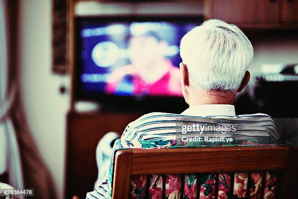 backview of solitary very old man watching tv - man watching tv alone bildbanksfoton och bilder