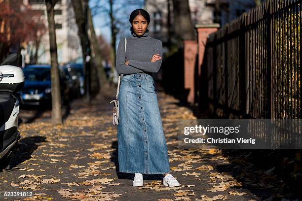 Yusnely Negret Cruz wearing a grey turtleneck sweater Comptoir des Cotonniers, a long denim skirt C&A, white Adidas sneaker on November 15, 2016 in...