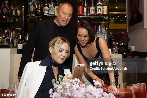 Kate Hudson, Michael Kors and Alina Cho share a moment during the Michael Kors Mandarin Gallery Flagship Store Opening Private Dinner at CUT at...