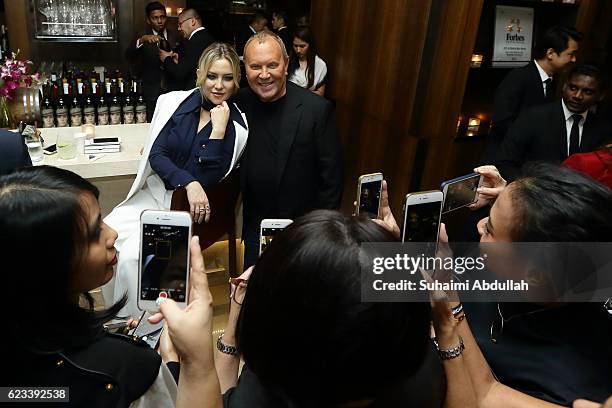 Guests take photos of American actress, Kate Hudson and American designer, Michael Kors during the Michael Kors Mandarin Gallery Flagship Store...