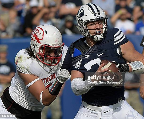 Quarterback Taysom Hill of the Brigham Young Cougars is pressured by Taylor Pili of the Southern Utah Thunderbirds during their game at LaVell...