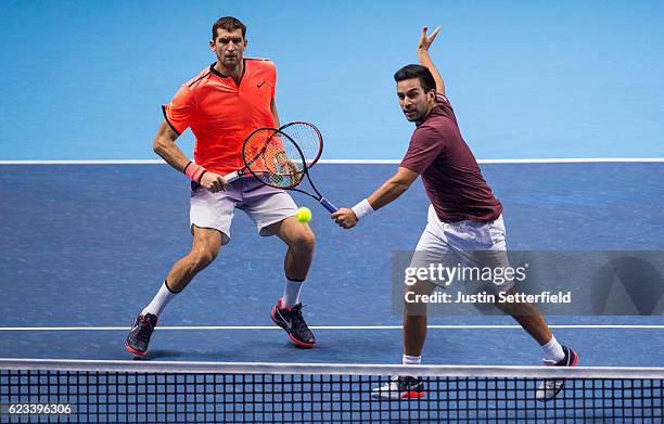 Max Mirnyi of Belarus and partner Treat Huey of the Philippines in action during their men's doubles match against Marcelo Melo of Brazil and his...