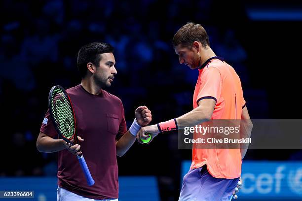 Max Mirnyi of Belarus celebrates a point with his partner Treat Huey of the Philippines during their men's doubles match against Ivan Dodig of...