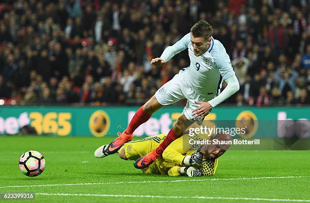 Pepe Reina of Spain fouls Jamie Vardy of England to concede a penalty during the international friendly match between England and Spain at Wembley...