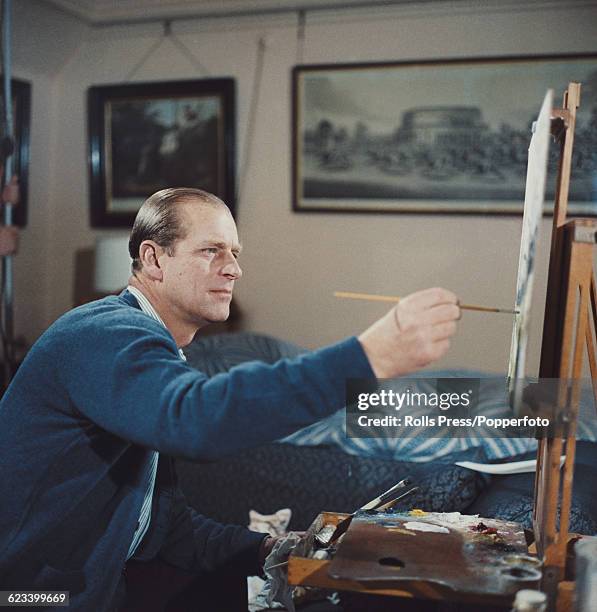 Prince Philip, Duke of Edinburgh pictured painting with oil colours at an easel during filming of the television documentary 'Royal Family' in London...