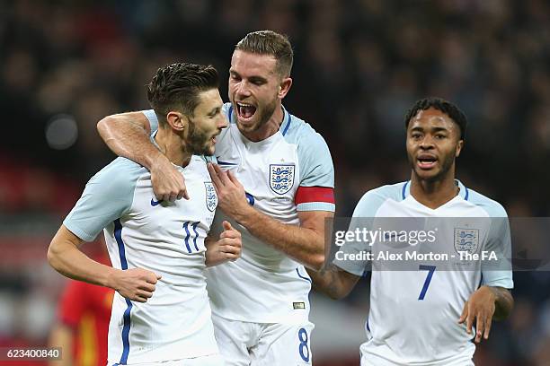 Adam Lallana of England is congratulated by Jordan Henderson after scoring the opening goal during the international friendly match between England...