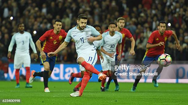 Adam Lallana of England scores the opening goal of the game from the penalty spot past goalkeeper Pepe Reina of Spain during the international...
