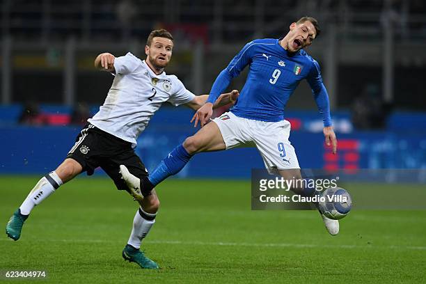 Andrea Belotti of Italy is challenged by Shkodran Mustafi during the International Friendly Match between Italy and Germany at Giuseppe Meazza...