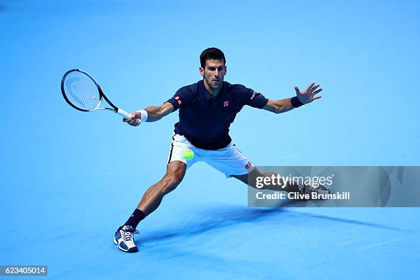 Novak Djokovic of Serbia hits a forehand during his men's singles match against Milos Raonic of Canada on day three of the ATP World Tour Finals at...